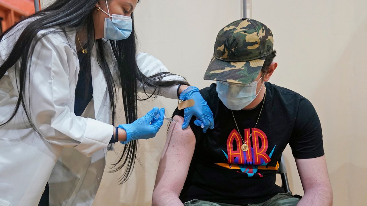 Alejandro Garcia, 16, receives his first dose of the Pfizer COVID-19 vaccine in West New York, N.J., Monday, April 19, 2021. (AP Photo/Seth Wenig)