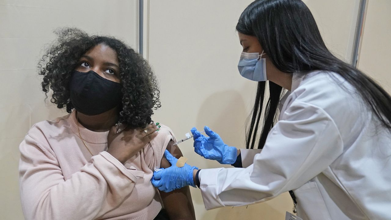 Keidy Ventura, 17, receives her first dose of the Pfizer COVID-19 vaccine in West New York, N.J., Monday, April 19, 2021. (AP Photo/Seth Wenig)