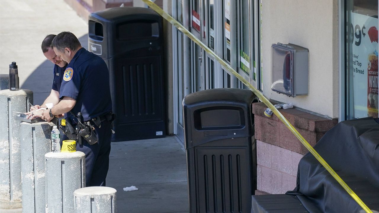 Emergency service personnel work at the scene of a shooting at a Stop & Shop supermarket Tuesday in West Hempstead, N.Y. (AP Photo/Mary Altaffer)