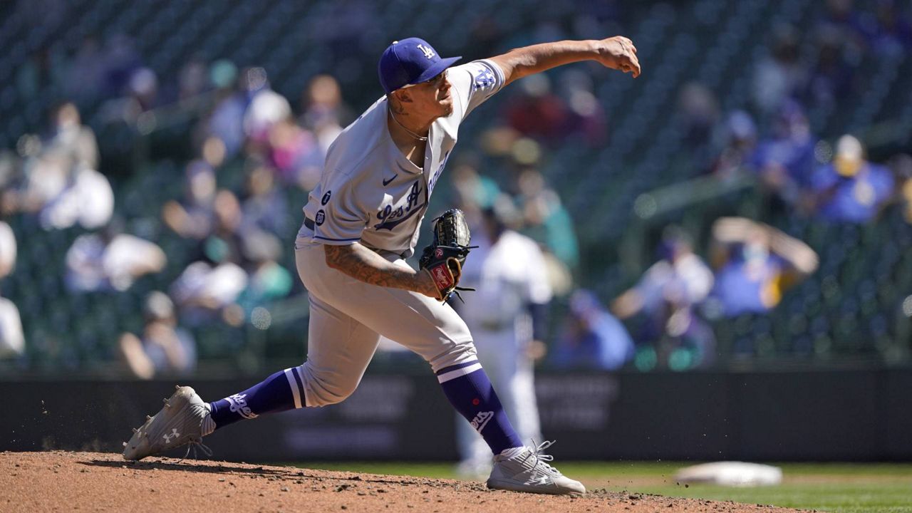 Los Angeles Dodgers starting pitcher Julio Urias throws against the Seattle Mariners in the fourth inning of a baseball game Tuesday, April 20, 2021, in Seattle. (AP Photo/Ted S. Warren)