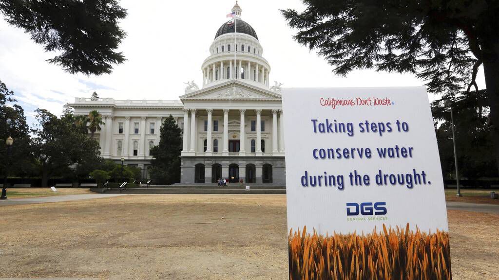 In this July 8, 2014, file photo, is a sign alerting visitors to water conservation efforts at the state Capitol in Sacramento, Calif. (AP Photo/Rich Pedroncelli, File)
