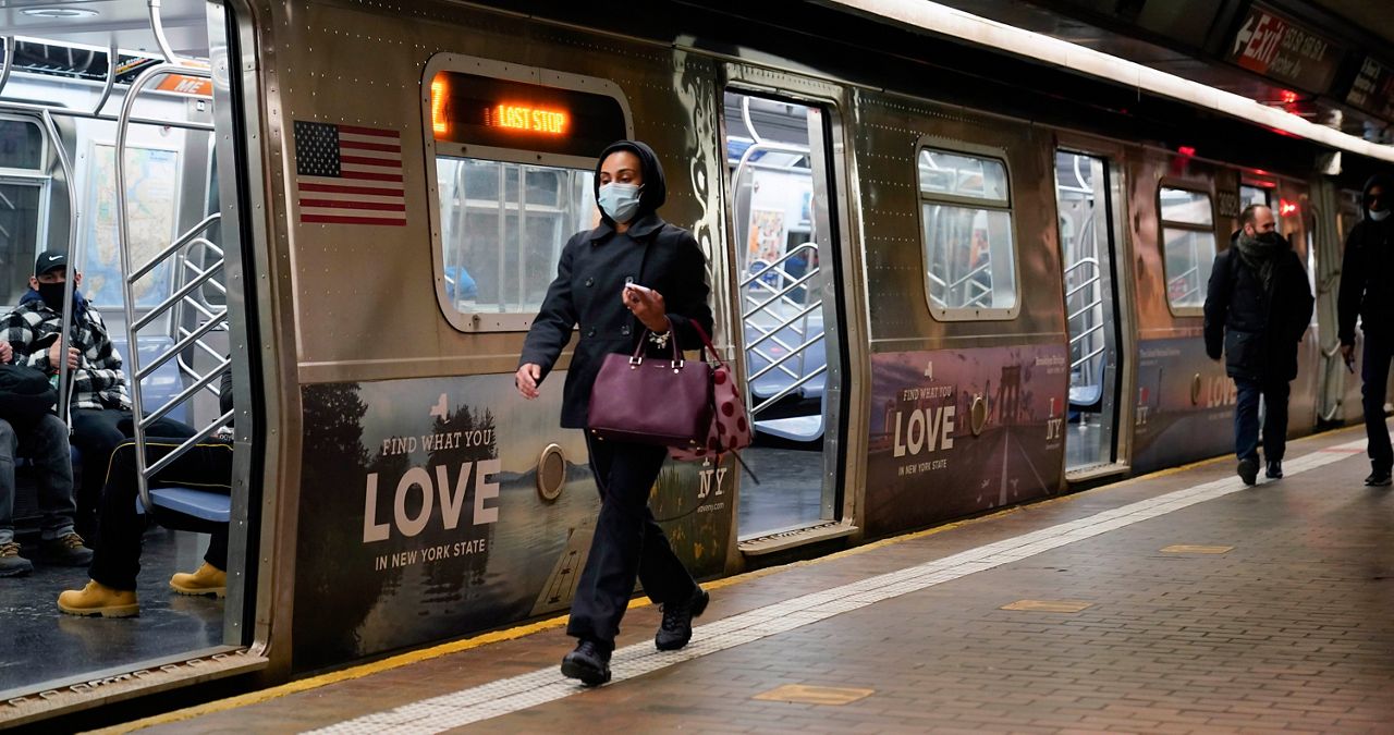 A March 9, 2021, file photo of people wearing masks to protect themselves against coronavirus transmission while riding the M train in the city