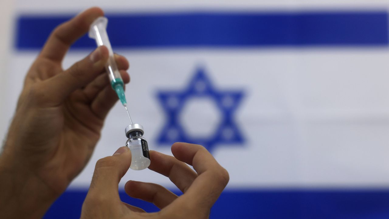An Israeli military paramedic prepares a Pfizer COVID-19 vaccine. (AP Photo/Tsafrir Abayov, File)