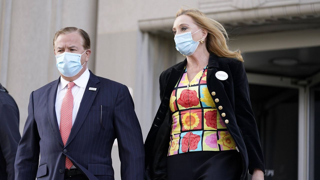 In this Oct. 14, 2020, file photo, Mark and Patricia McCloskey leave following a court hearing in St. Louis.  (AP Photo/Jeff Roberson, File)