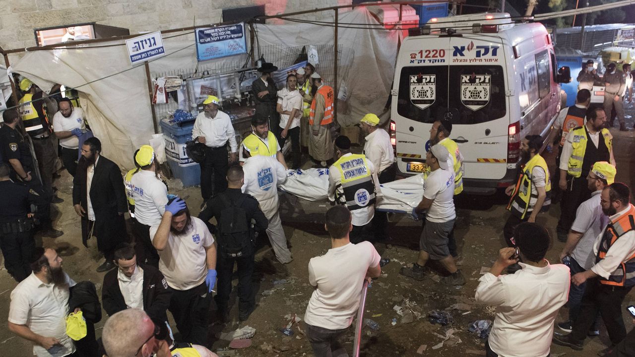 Israeli security officials and rescuers carry a body of a victim who died during a Lag Ba'Omer celebrations at Mt. Meron in northern Israel, Friday, April 30, 2021. (AP Photo)