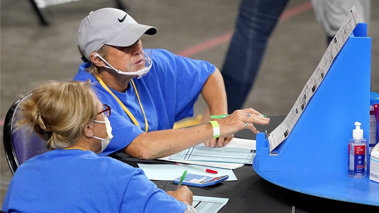 Maricopa County ballots are examined and recounted by contractors working for Cyber Ninjas on May 6 at Veterans Memorial Coliseum in Phoenix. (AP Photo/Matt York, Pool)