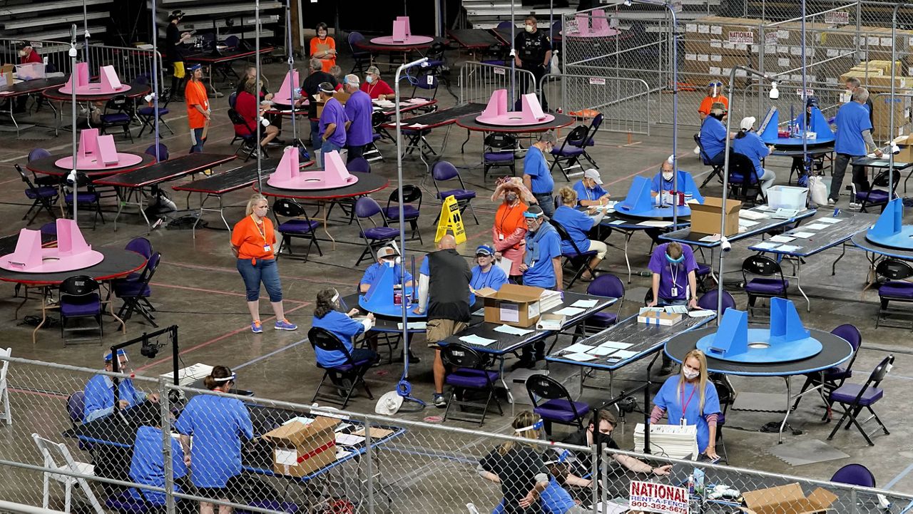 Maricopa County ballots are examined and recounted by contractors working for Cyber Ninjas on May 6 at Veterans Memorial Coliseum in Phoenix. (AP Photo/Matt York, Pool)