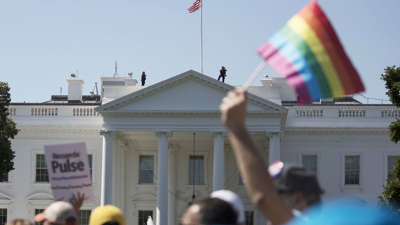 FILE - In this Sunday, June 11, 2017 file photo, Equality March for Unity and Pride participants march past the White House in Washington. (AP Photo/Carolyn Kaster)