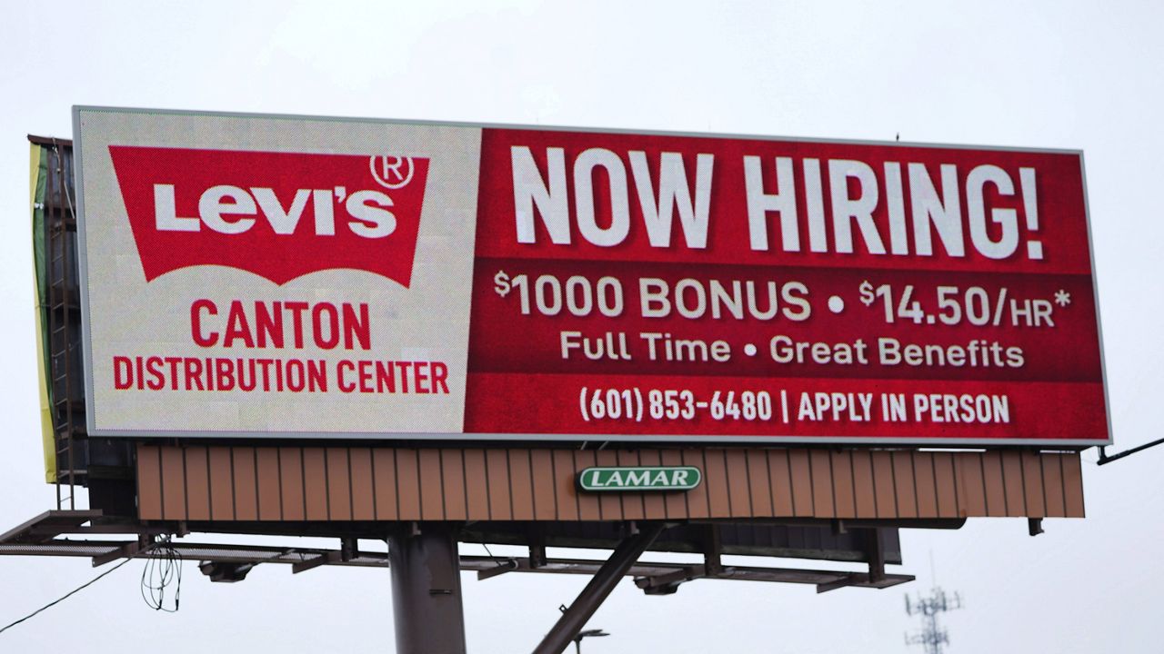 A billboard advertises job openings at a Levi's Distribution Center in Canton, Miss., on May 12. (AP Photo/Rogelio V. Solis)