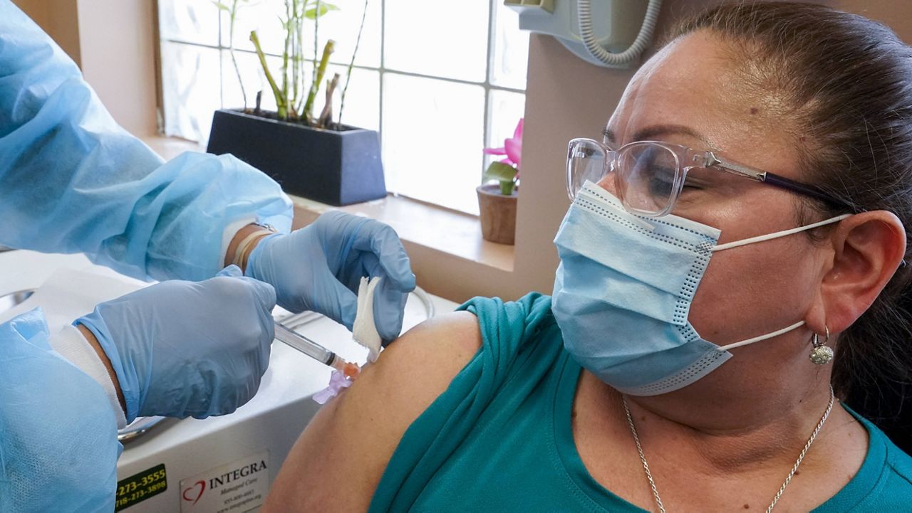Registered nurse Anna Yadgaro inoculates Juana Mejia with the Moderna COVID-19 vaccine on May 12, 2021 in the Queens borough of New York. (AP Photo/Mary Altaffer)