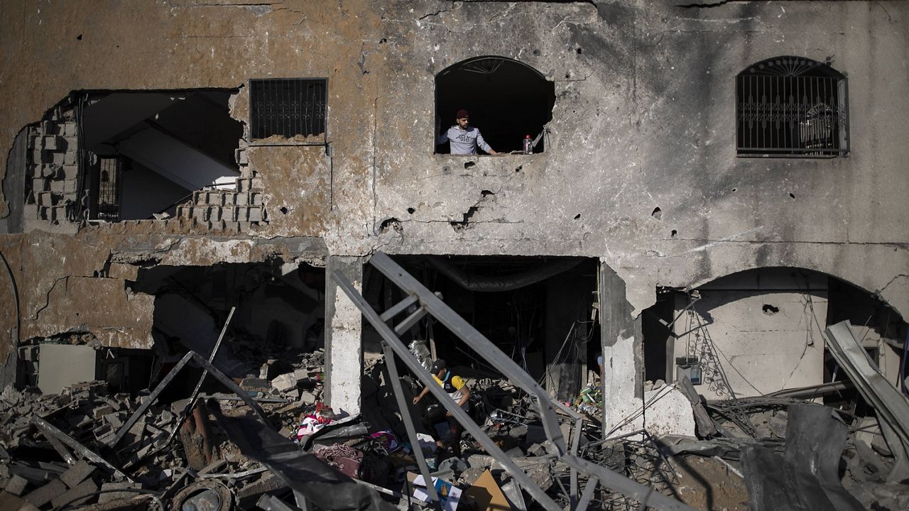 Palestinians inspect their destroyed home after being hit by Israeli airstrikes in town of Beit Lahiya, northern Gaza Strip, Thursday. (AP Photo/Khalil Hamra)