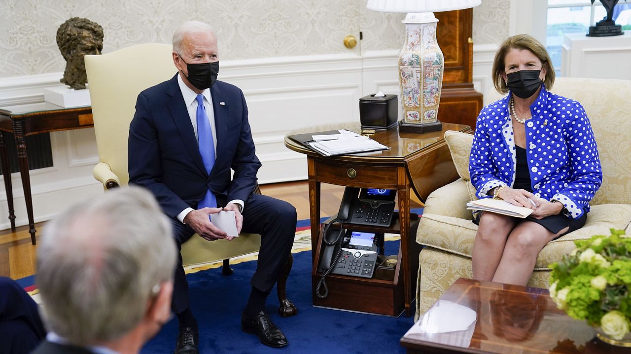 President Joe Biden speaks during a meeting in the Oval Office of the White House, Thursday, May 13, 2021, in Washington. Sen. Shelley Moore Capito, R-W.Va., right, and Sen. Mike Crapo, R-Idaho listen. (AP Photo/Evan Vucci)