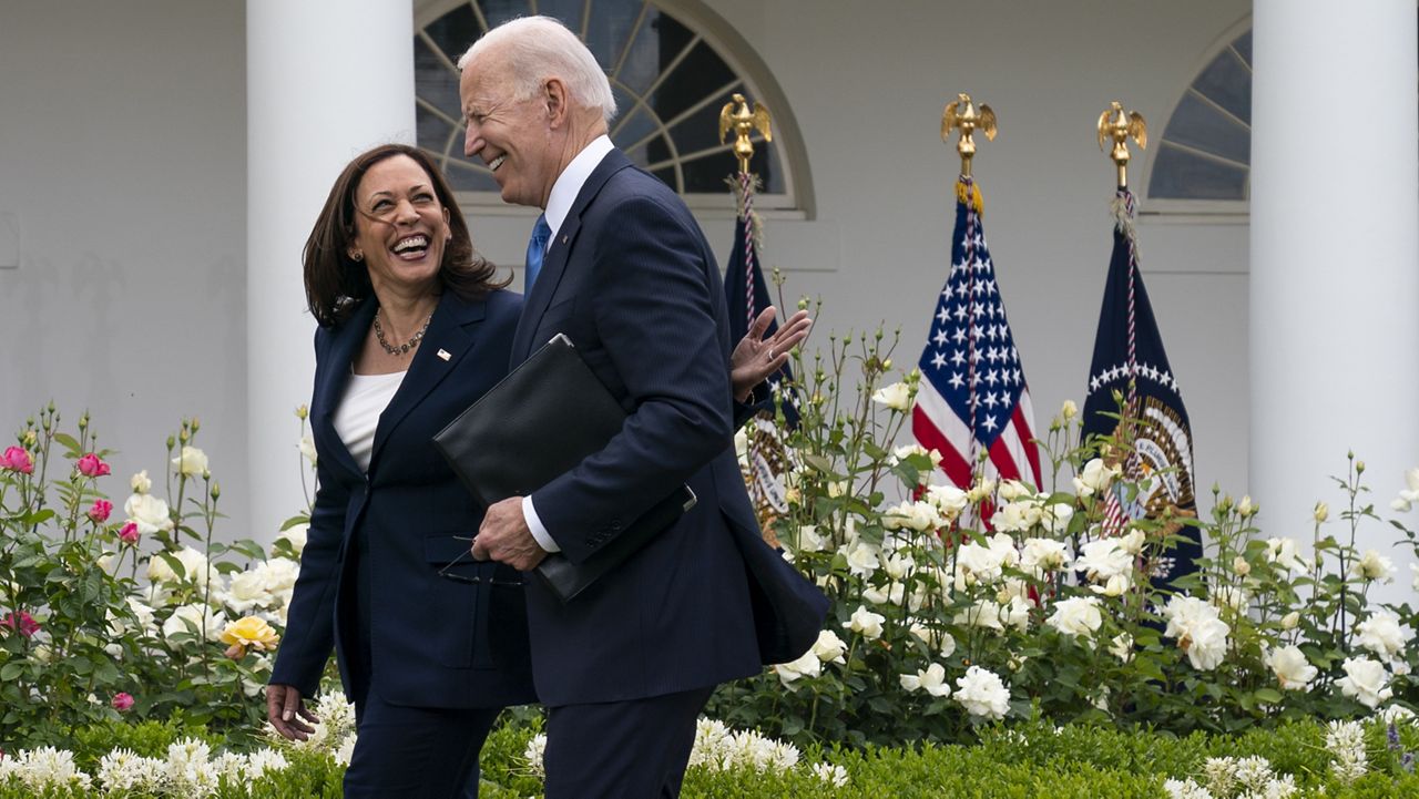 Vice President Kamala Harris and President Joe Biden smile and walk off after speaking about updated guidance on mask mandates, in the Rose Garden of the White House, Thursday, May 13, 2021, in Washington. (AP Photo/Evan Vucci)