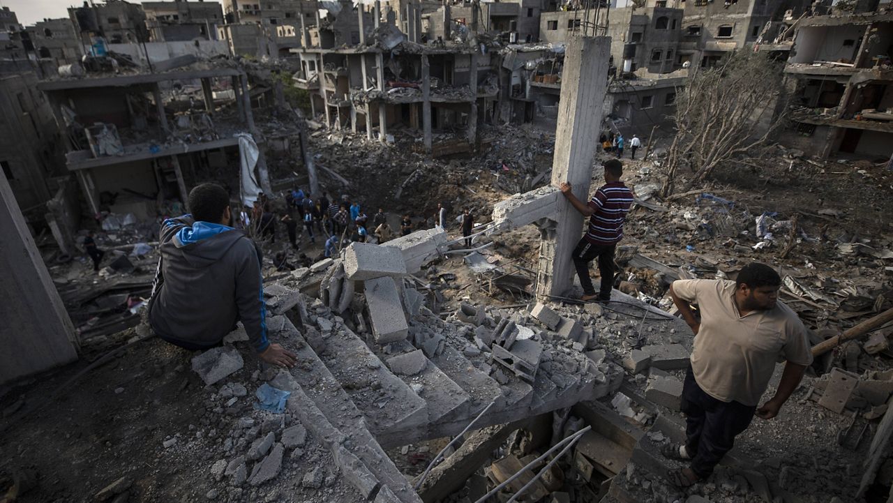 Palestinians inspect their destroyed houses following overnight Israeli airstrikes in town of Beit Hanoun, northern Gaza Strip, on Friday. (AP Photo/Khalil Hamra)