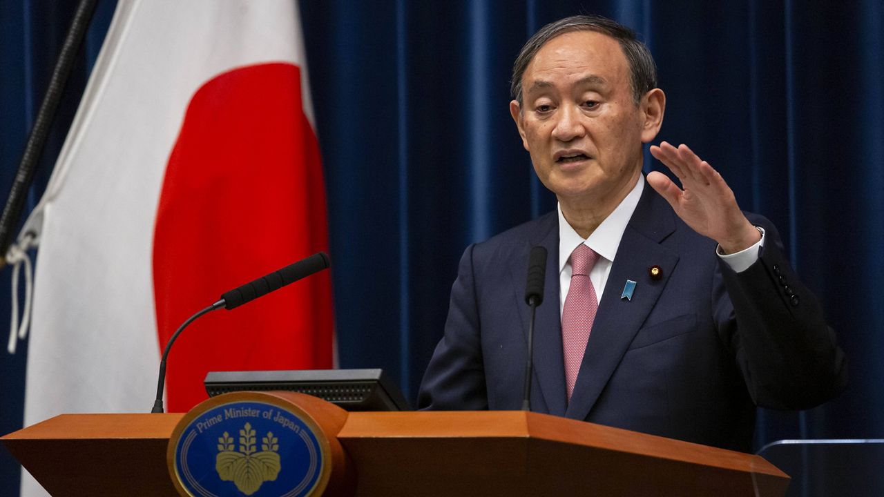 Japanese Prime Minister Yoshihide Suga speaks during a news conference Friday in Tokyo. (Yuichi Yamazaki/Pool Photo via AP)