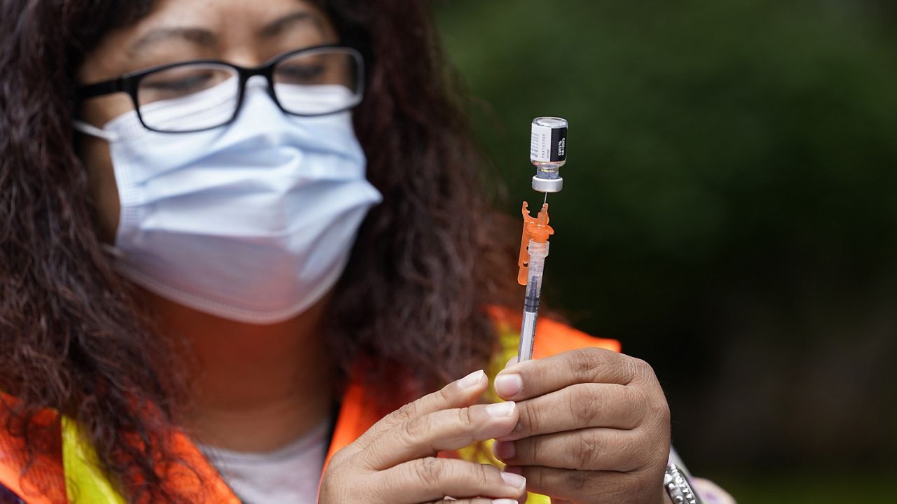 A shot of the Pfizer COVID-19 vaccine is prepared at the First Baptist Church of Pasadena Friday, May 14, 2021, in Pasadena, Calif. (AP Photo/Marcio Jose Sanchez)