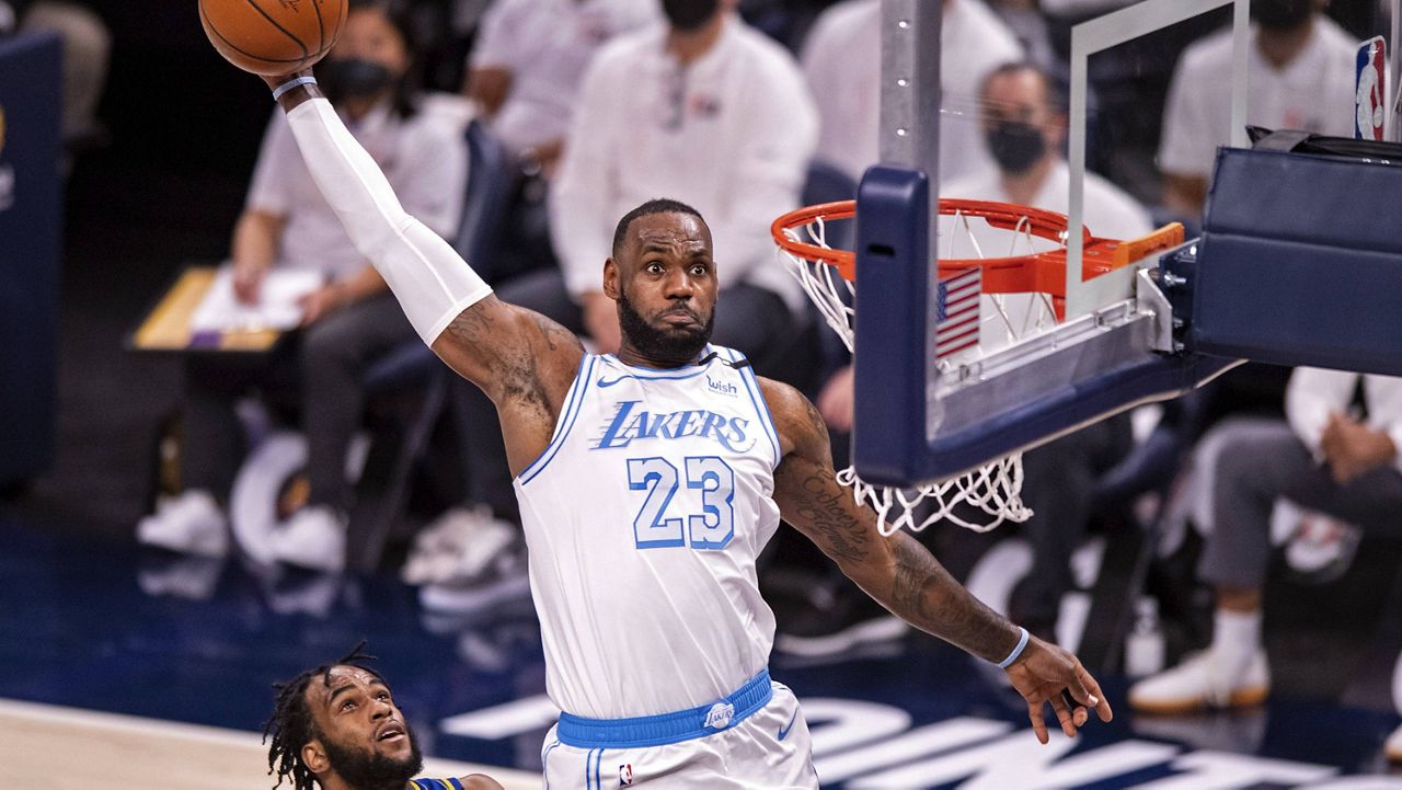 Los Angeles Lakers forward LeBron James (23) goes up high to dunk the ball during the first half of an NBA basketball game against the Indiana Pacers in Indianapolis, Saturday, May 15, 2021. (AP Photo/Doug McSchooler)