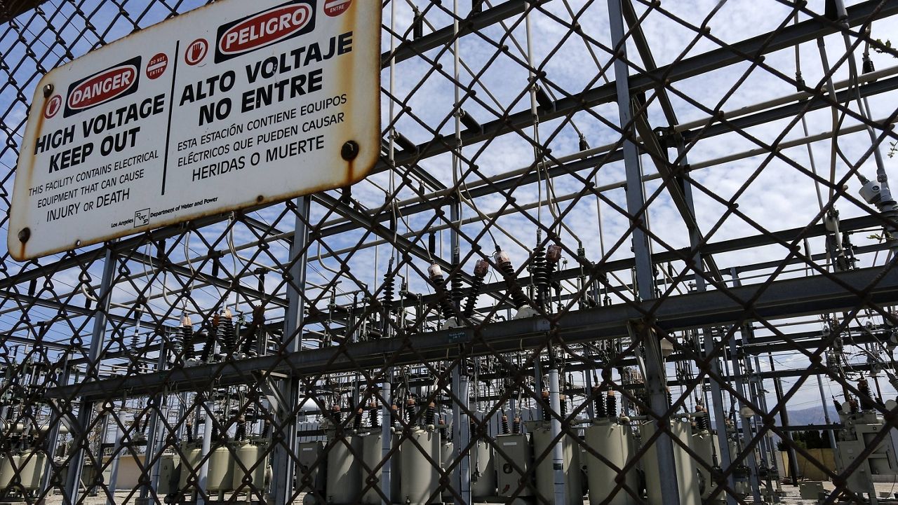 High voltage signs are posted on the Department of Water and Power Sub Station E in the North Hollywood section of Los Angeles on Aug. 15, 2020. (AP Photo/Richard Vogel)