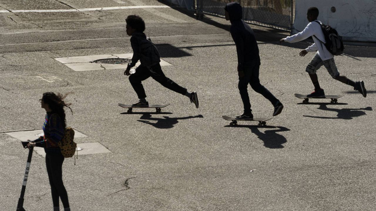 Youngsters ride their skateboards in Long Beach, Calif., May 22, 2021. (AP Photo/Damian Dovarganes)