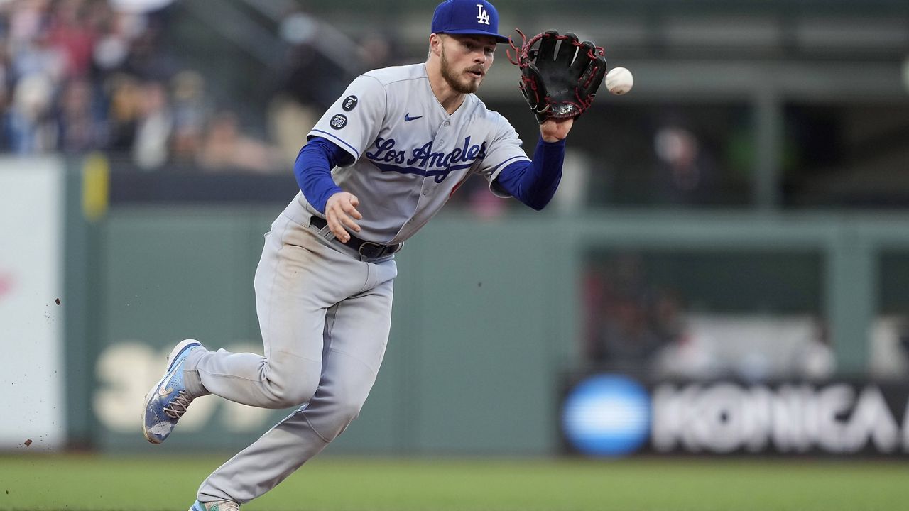 Los Angeles Dodgers shortstop Gavin Lux reaches out to field a ground ball hit by San Francisco Giants' Mauricio Dubon before throwing to first base for the final out during the ninth inning of a baseball game Saturday, May 22, 2021, in San Francisco. (AP Photo/Tony Avelar)