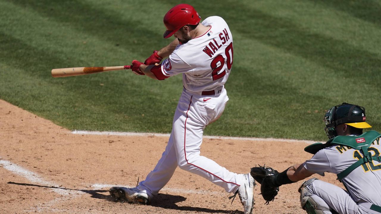 Los Angeles Angels' Jared Walsh (20) hits a home run during the sixth inning of a baseball game against the Oakland Athletics Sunday, May 23, 2021, in Anaheim, Calif. (AP Photo/Ashley Landis)