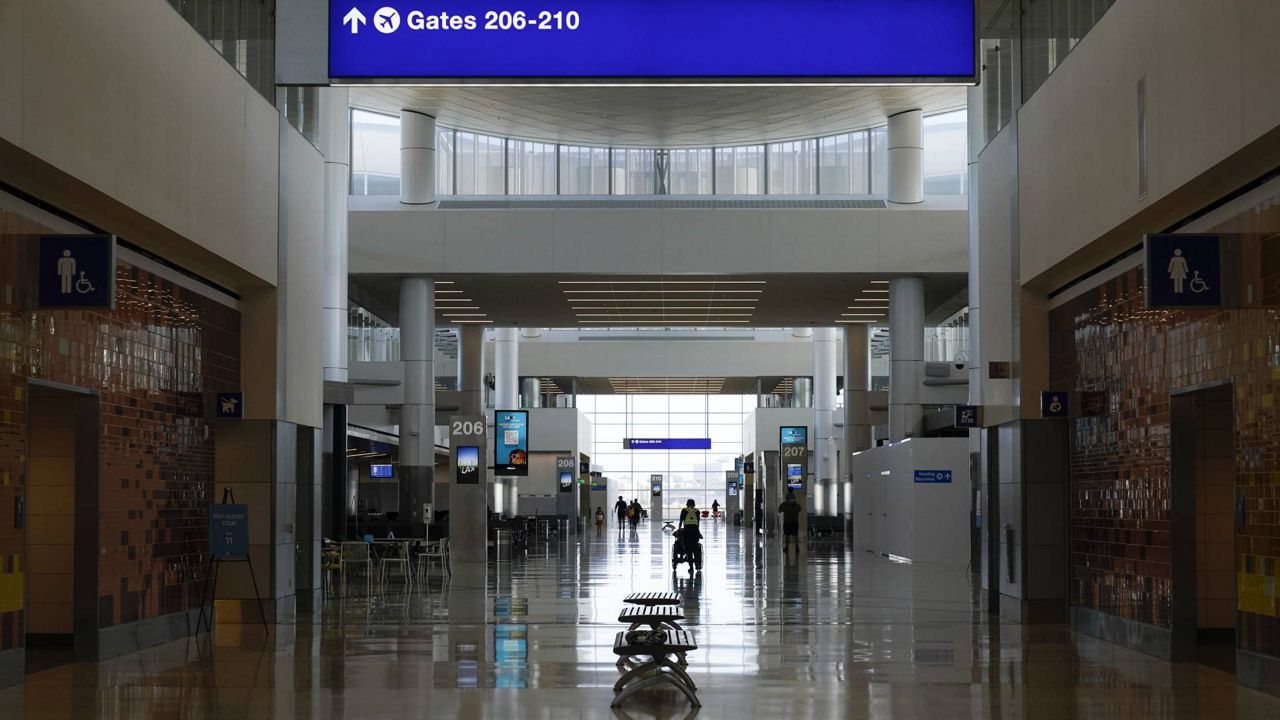 Passengers walk through the new West Gates at Tom Bradley International Terminal at Los Angeles International Airport, May 24, 2021. (AP Photo/Ashley Landis)