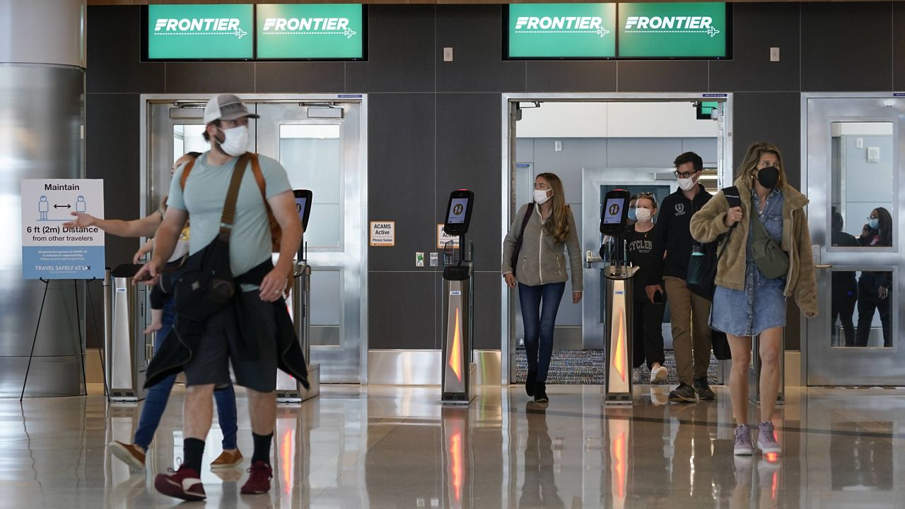 Passengers arrive at the new West Gates at Tom Bradley International Terminal at Los Angeles International Airport Monday, May 24, 2021, in Los Angeles. (AP Photo/Ashley Landis)