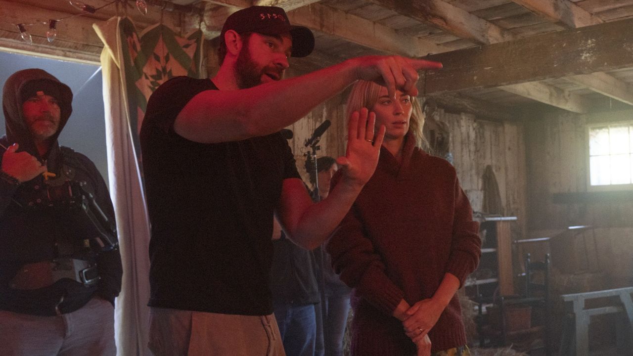 This image released by Paramount Pictures shows director John Krasinski, left, and Emily Blunt on the set of "A Quiet Place Part II." (Jonny Cournoyer/Paramount Pictures via AP)
