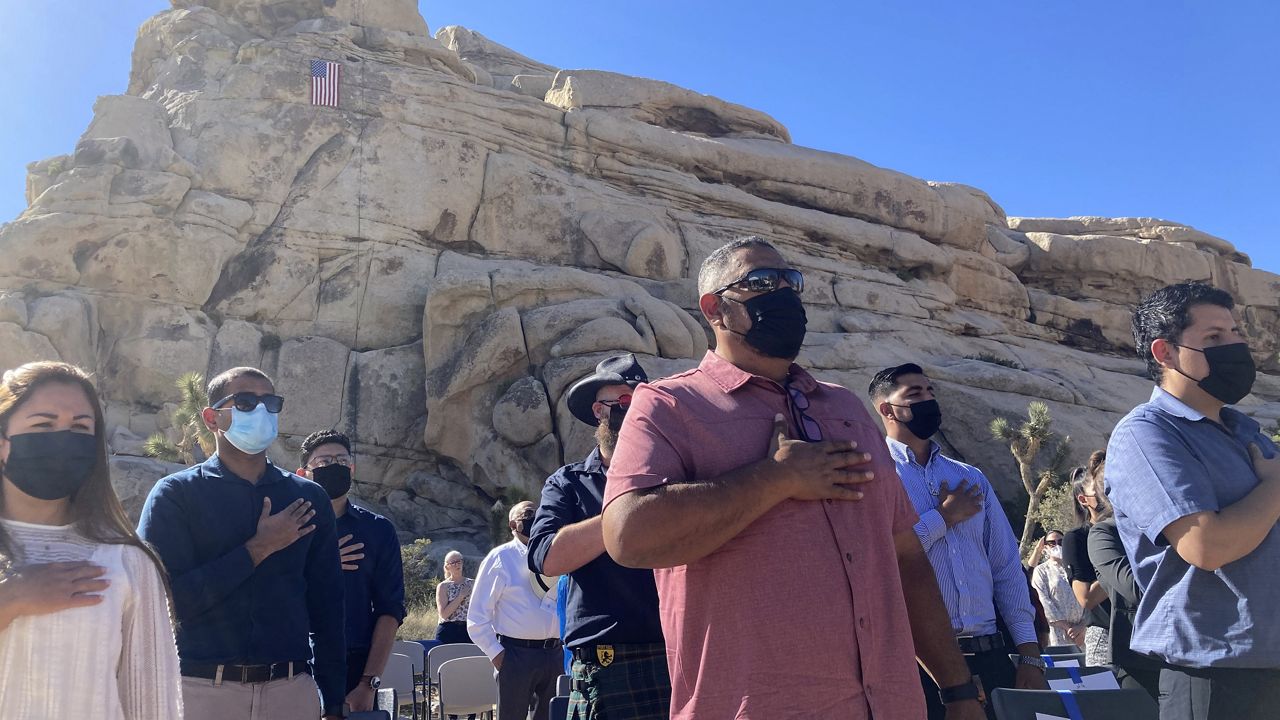 People take part in a naturalization ceremony to become U.S. citizens, May 4, 2021, in Joshua Tree National Park, Calif. (AP Photo/Elliot Spagat)