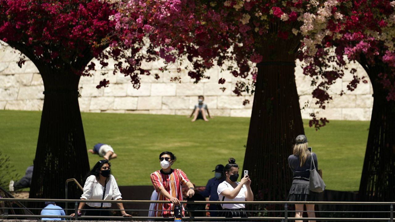 Visitors wear masks while visiting a garden at the newly reopened Getty Center amid the COVID-19 pandemic, May 26, 2021, in Los Angeles. (AP Photo/Marcio Jose Sanchez)