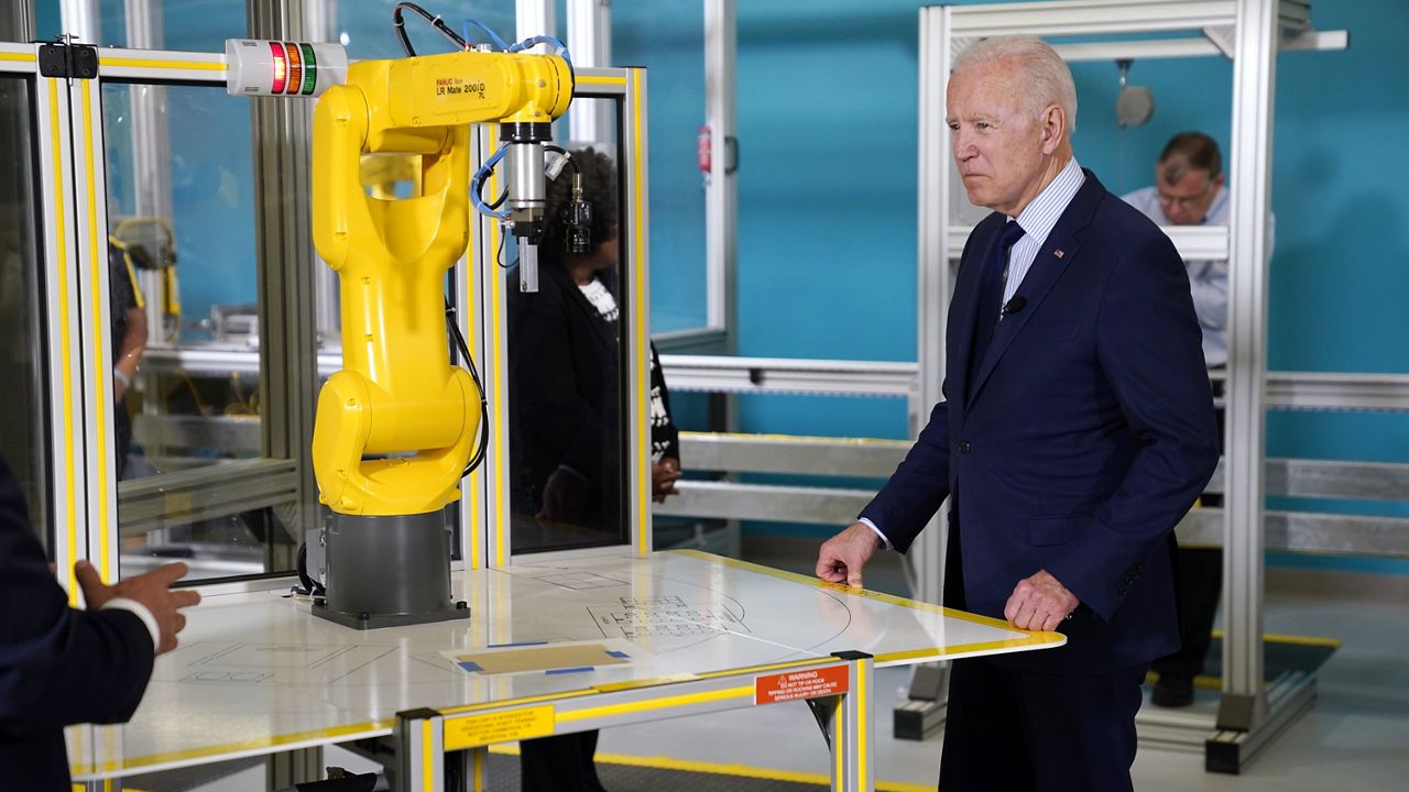 President Joe Biden listens during a tour of the Cuyahoga Community College Manufacturing Technology Center, Thursday, May 27, 2021, in Cleveland. (AP Photo/Evan Vucci)