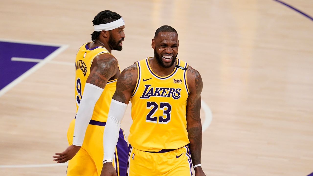 Los Angeles Lakers forward LeBron James (23) smiles with guard Wesley Matthews (9) during the second half in Game 3 of an NBA basketball first-round playoff series against the Phoenix Suns Thursday, May 27, 2021, in Los Angeles. (AP Photo/Marcio Jose Sanchez)
