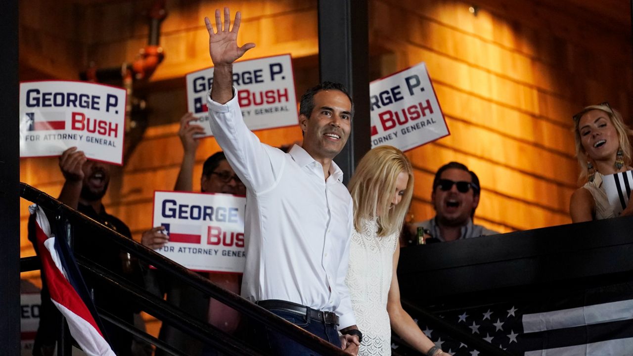 Texas Land Commissioner George P. Bush arrives for a kick-off rally with his wife Amanda to announce he will run for Texas Attorney General, Wednesday, June 2, 2021, in Austin, Texas. (AP Photo/Eric Gay)