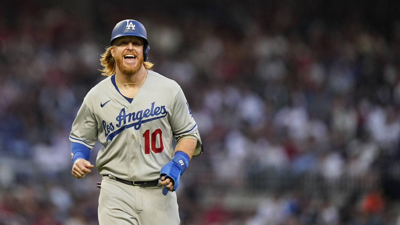 Los Angeles Dodgers' Justin Turner (10) runs to first base after a walk in the fourth inning of a baseball game against the Atlanta Braves Friday, June 4, 2021, in Atlanta. (AP Photo/Brynn Anderson)