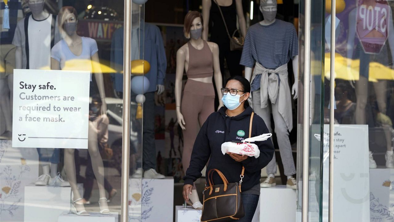 In this May 20, 2021 file photo, fashions include cloth masks inside a store amid the COVID-19 pandemic, at The Grove in Los Angeles. (AP Photo/Marcio Jose Sanchez)