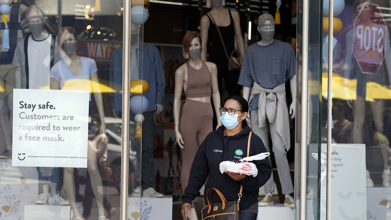 In this May 20, 2021 file photo fashions include cloth masks inside a store amid the COVID-19 pandemic, at The Grove in Los Angeles. (AP Photo/Marcio Jose Sanchez, file)