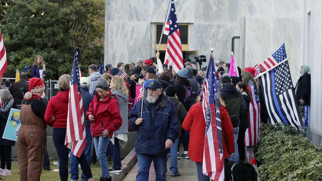 Pro-Trump and anti-mask demonstrators hold a rally outside the Oregon State Capitol on Dec. 21. (AP Photo/Andrew Selsky, File)