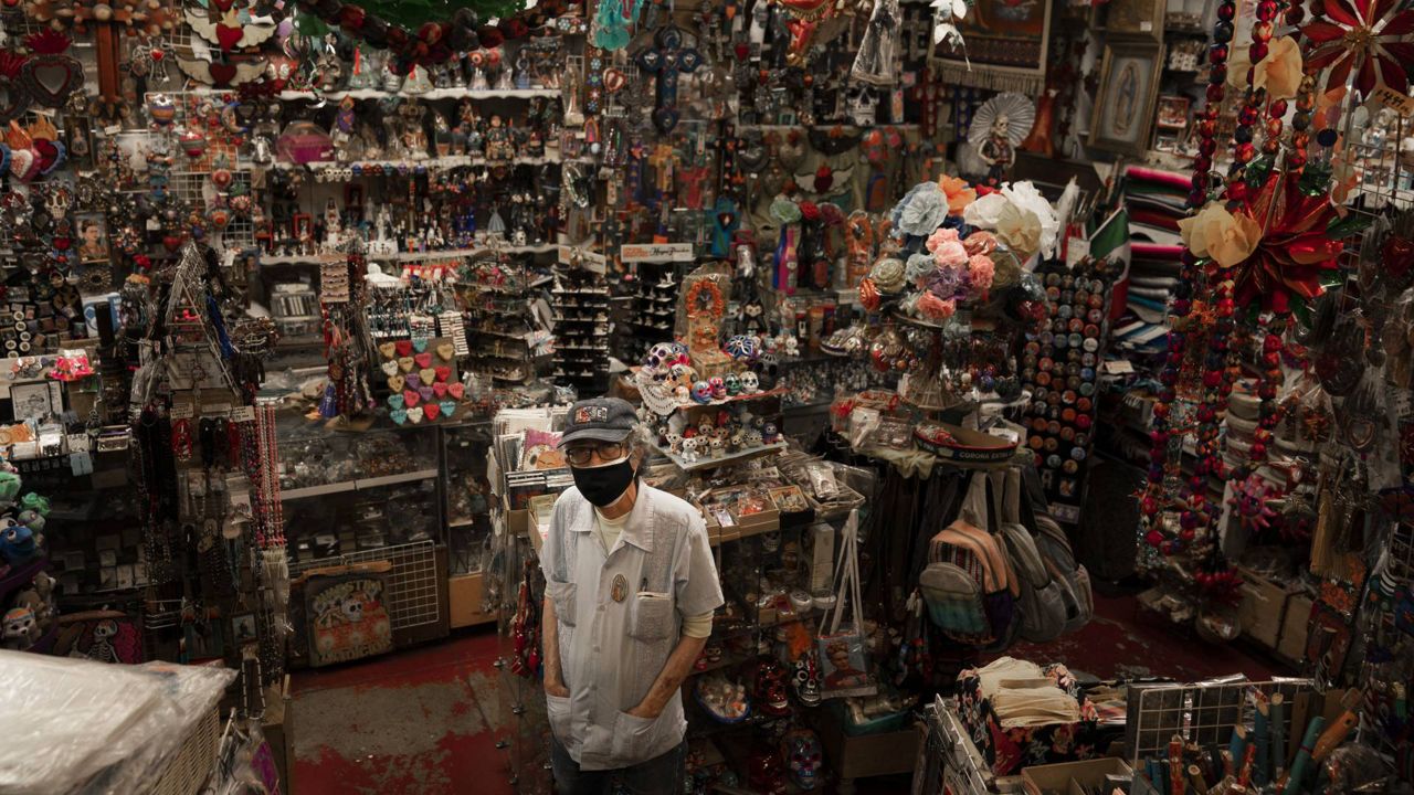 Mike Mariscal, owner of Myrosa Enterprises souvenir shop on Olvera Street, stands for a photo in his store in Los Angeles, June 4, 2021. (AP Photo/Jae C. Hong)