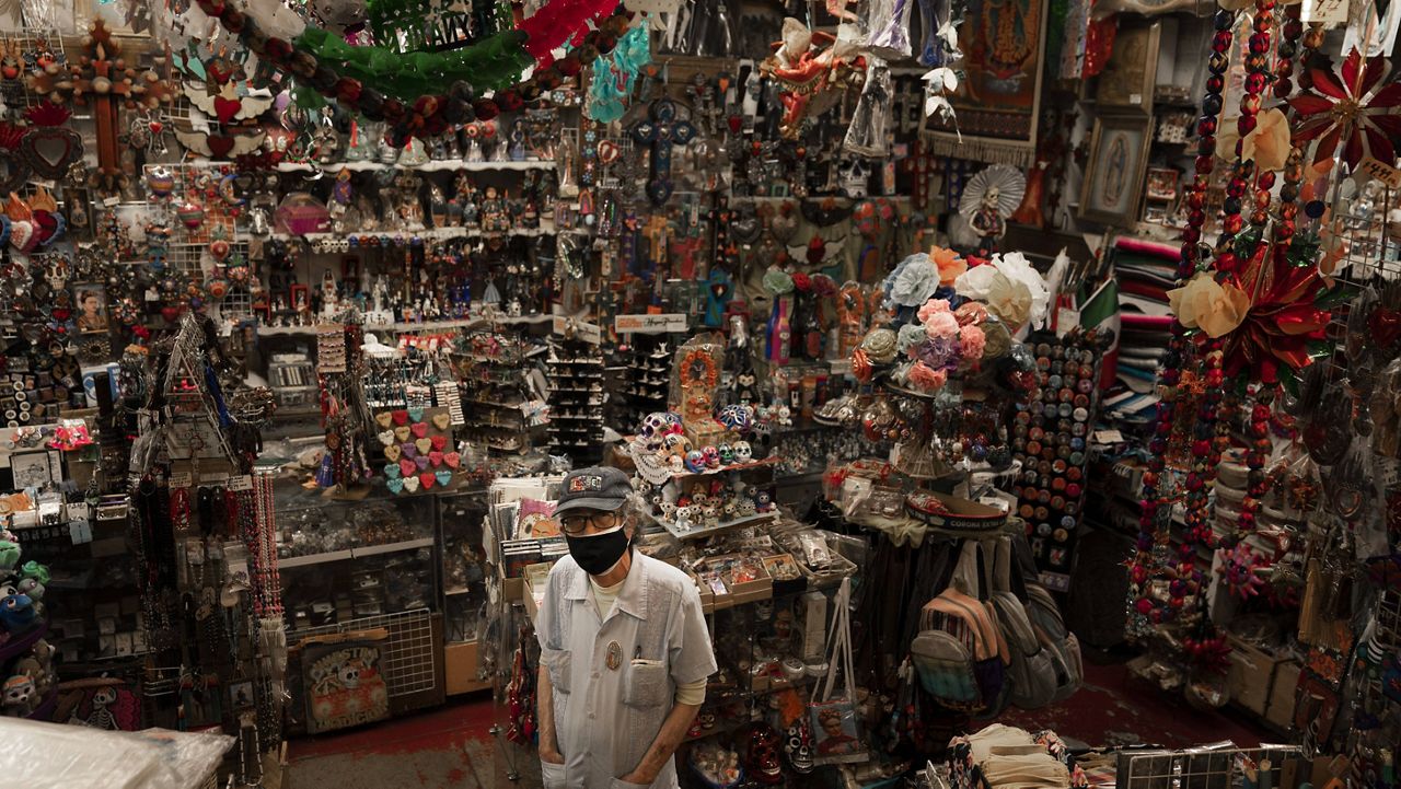 Mike Mariscal, owner of Myrosa Enterprises souvenir shop on Olvera Street, stands for a photo in his store in Los Angeles, Friday, June 4, 2021. (AP Photo/Jae C. Hong)