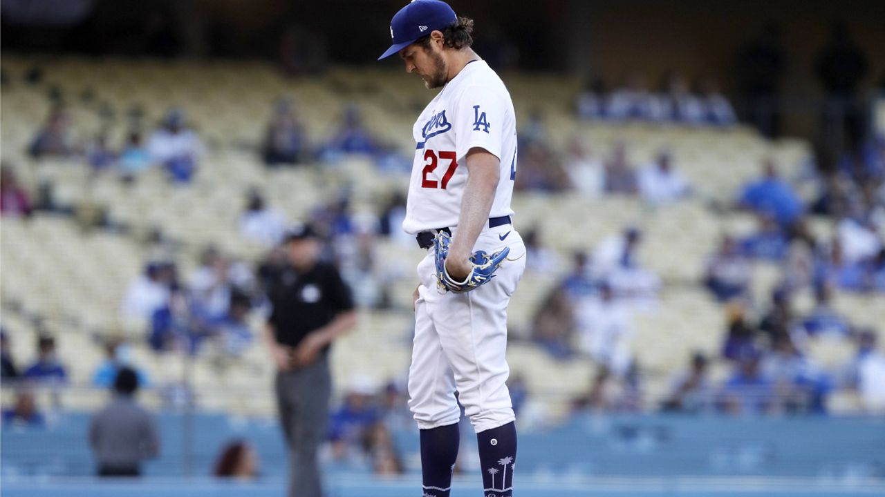 Los Angeles Dodgers starting pitcher Trevor Bauer gathers himself at the mound before baseball game against the Texas Rangers in Los Angeles, Saturday, June 12, 2021. (AP Photo/Alex Gallardo)