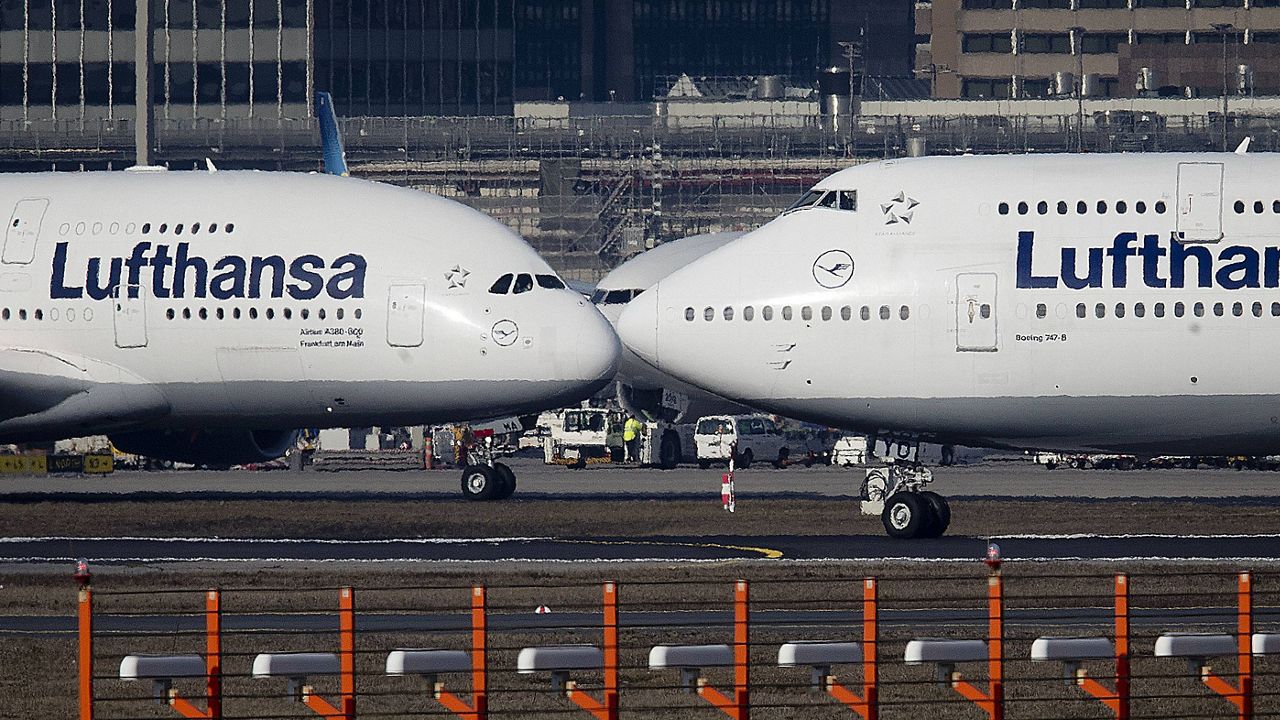 In this Feb. 14, 2019, file photo, an Airbus A380, left, and a Boeing 747, both from Lufthansa airline, pass each other at the airport in Frankfurt, Germany. (AP Photo/Michael Probst, File)