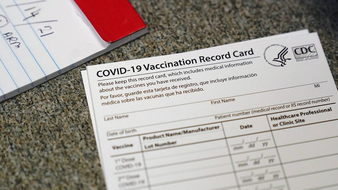 In this Dec. 24, 2020, file photo, a COVID-19 vaccination record card is shown at Seton Medical Center in Daly City, Calif. (AP Photo/Jeff Chiu, File)