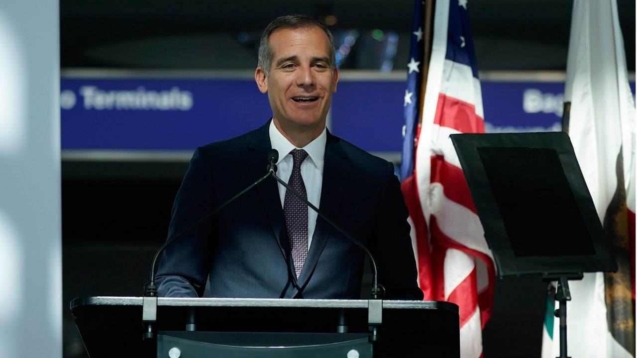 In this May 24, 2021, file photo, Los Angeles Mayor Eric Garcetti speaks a news conference at Los Angeles International Airport in Los Angeles. A group of 11 U.S. mayors have pledged to pay reparations for slavery to a small group of Black residents in their cities. The mayors have committed to form commissions to advise them on how to develop the programs. (AP Photo/Ashley Landis)
