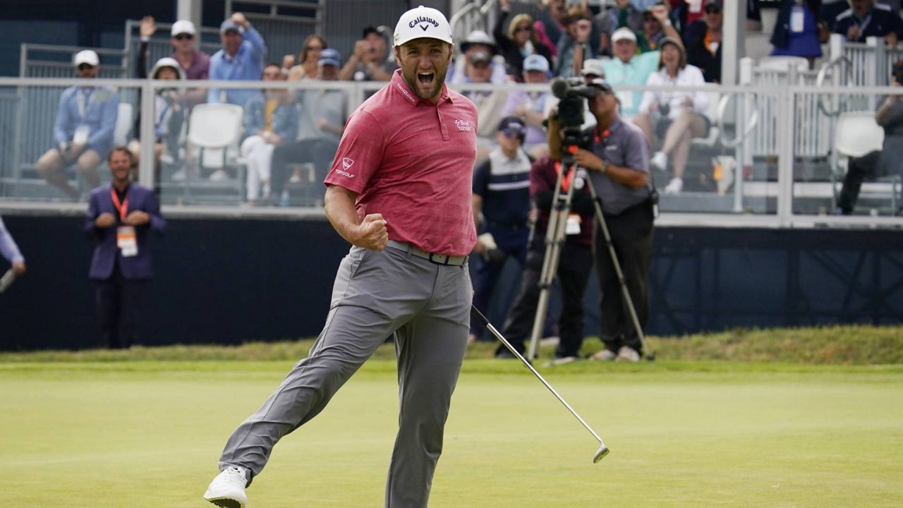 Jon Rahm, of Spain, reacts to making his birdie putt on the 18th green during the final round of the U.S. Open Golf Championship, Sunday, June 20, 2021, at Torrey Pines Golf Course in San Diego. (AP Photo/Gregory Bull)
