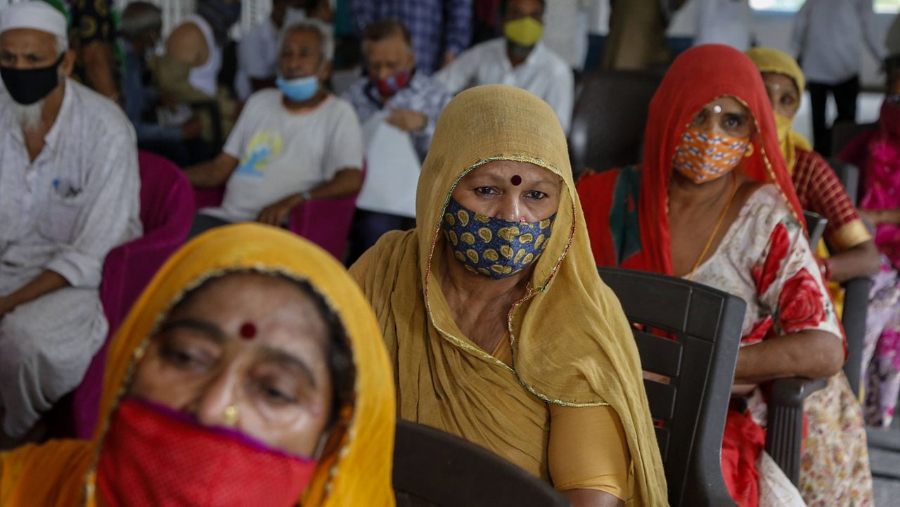 People line up at a COVID-19 vaccination drive at a mosque in Ahmedabad, India, on Monday. (AP Photo/Ajit Solanki)