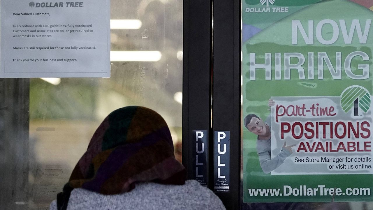 A shopper enters a store with a hiring sign on the door in Buffalo Grove, Ill., on June 24. (AP Photo/Nam Y. Huh)