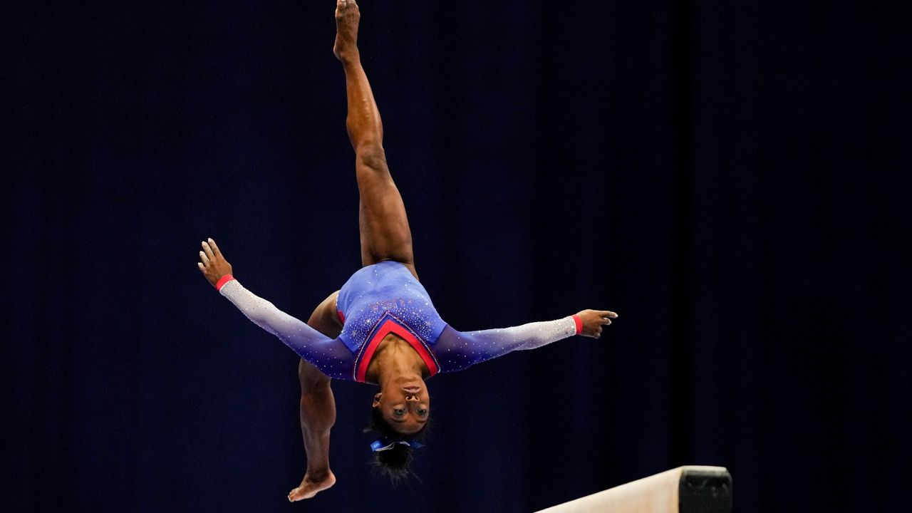 Simone Biles competes on the balance beam during the women's U.S. Olympic Gymnastics Trials Friday, June 25, 2021, in St. Louis. (AP Photo/Jeff Roberson)
