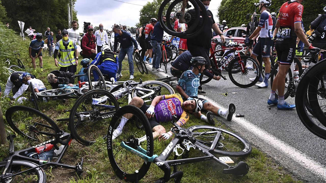 Italy's Kristian Sbaragli, left, and France's Bryan Coquard, right, lie on the ground after crashing during the first stage of the Tour de France on Saturday. (Anne-Christine Poujoulat, Pool Photo via AP)