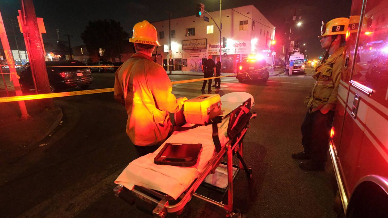 Emergency personnel stand near the scene of a fireworks explosion in Los Angeles on June 30, 2021. (AP Photo/Ringo H.W. Chiu)