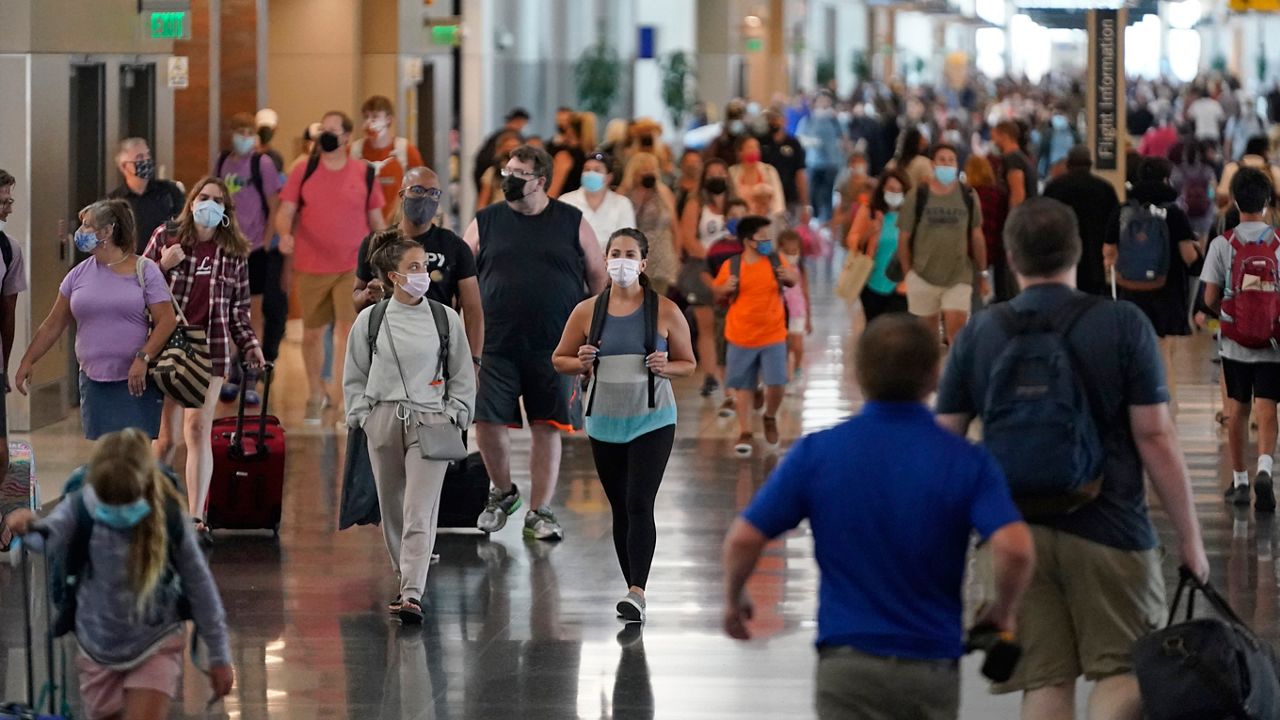 FILE: People walk through Salt Lake City International Airport Thursday, July 1, 2021, in Salt Lake City. (AP Photo/Rick Bowmer)